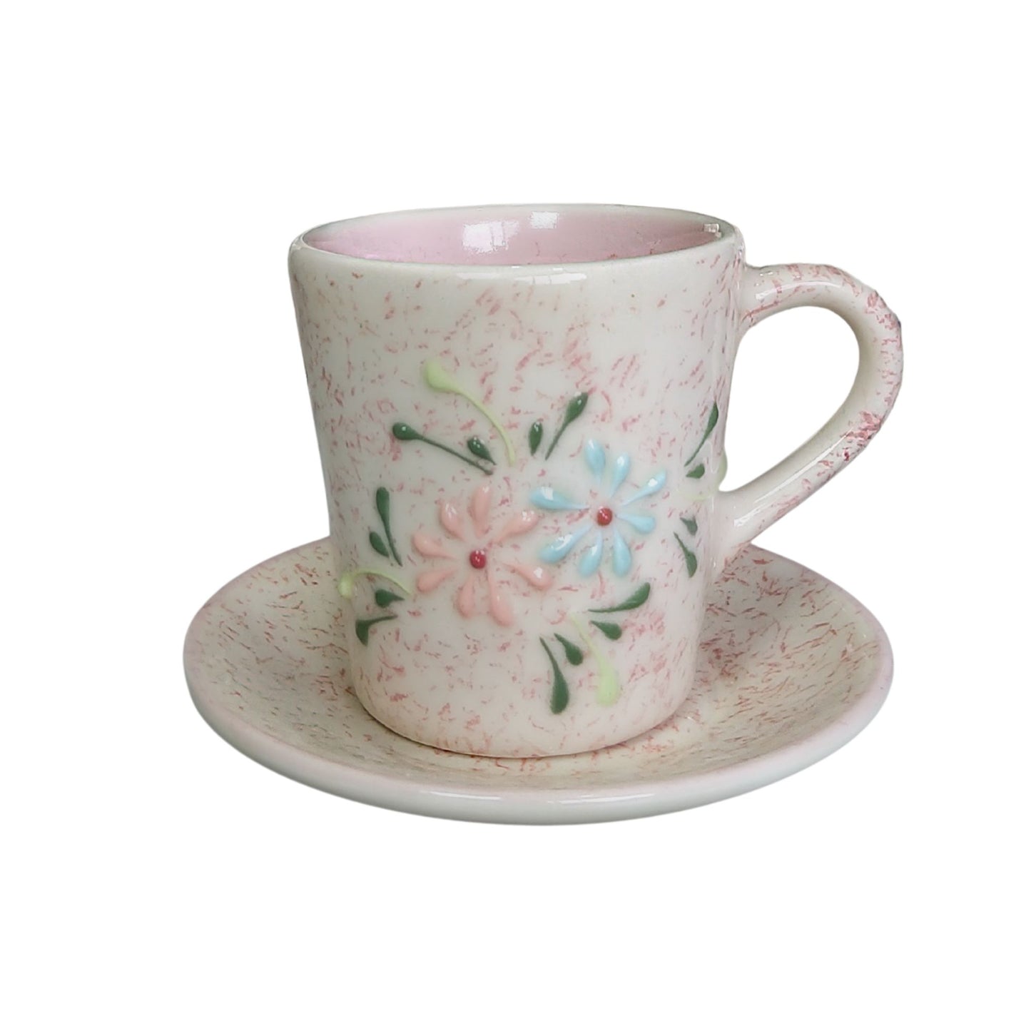 Ceramic cup and saucer with floral design on a white background