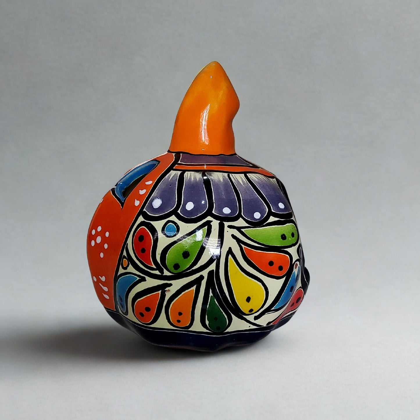 Decorative ceramic vase with colorful floral patterns on a gray background