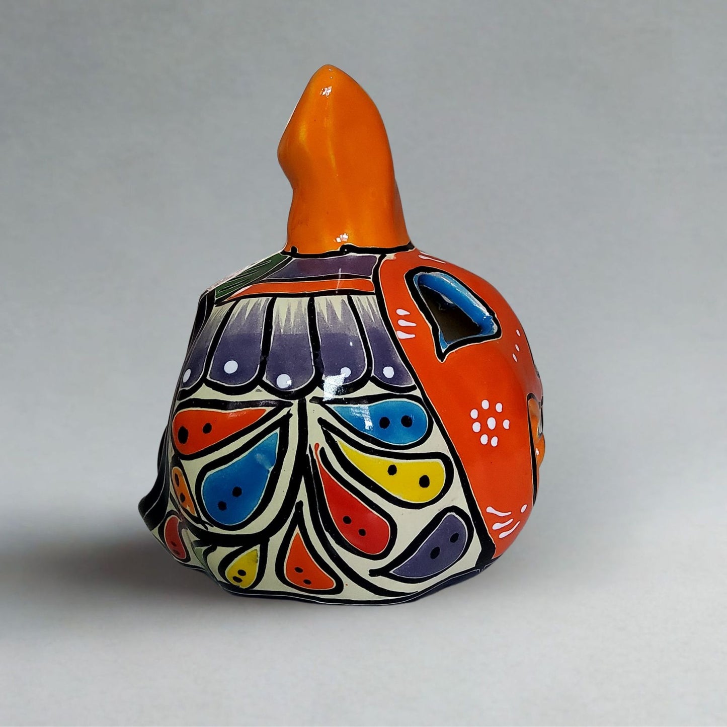 Colorful ceramic bottle with abstract patterns on a gray background